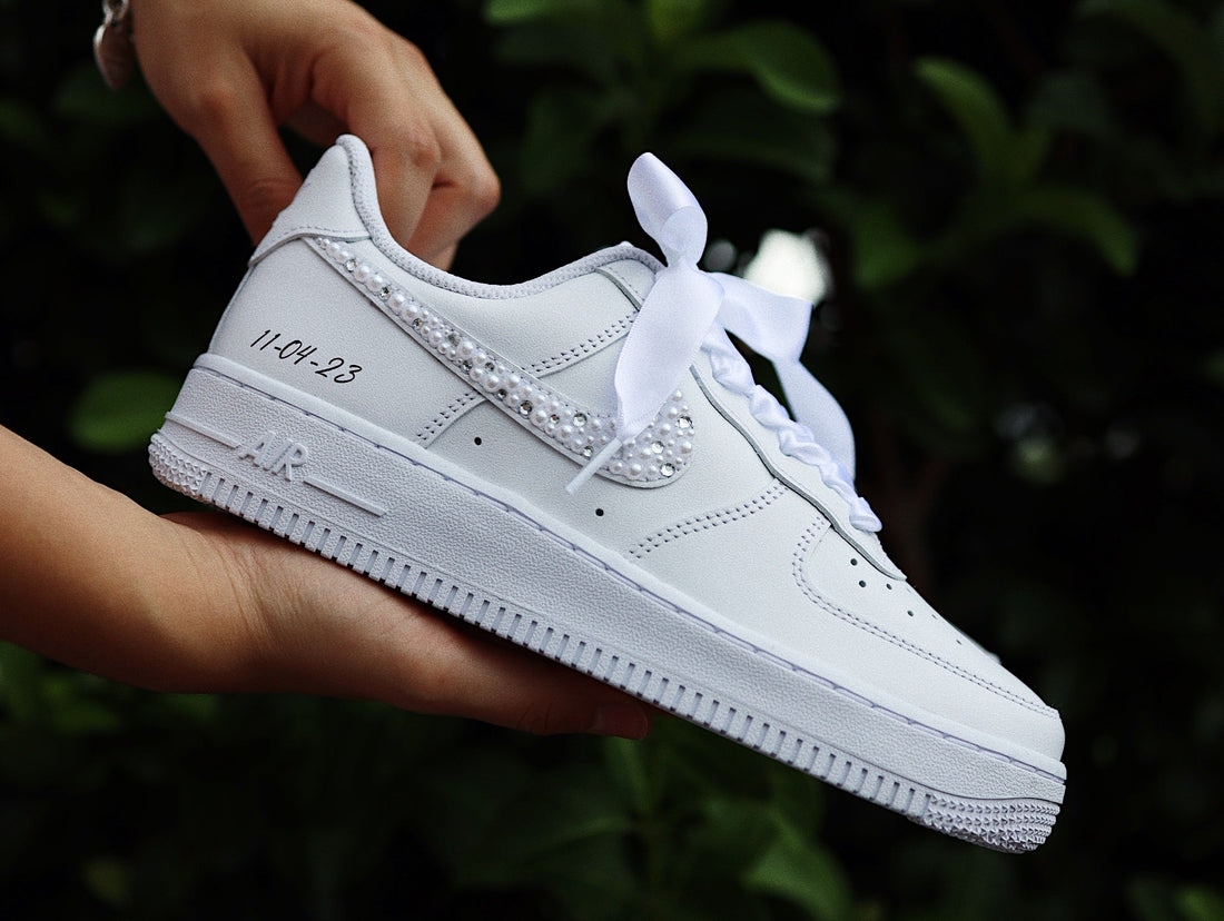 White custom wedding sneakers with pearl trim and a hand-written date