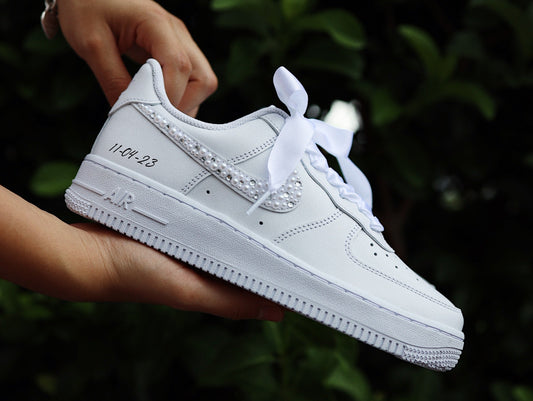 White custom wedding sneakers with pearl trim and a hand-written date